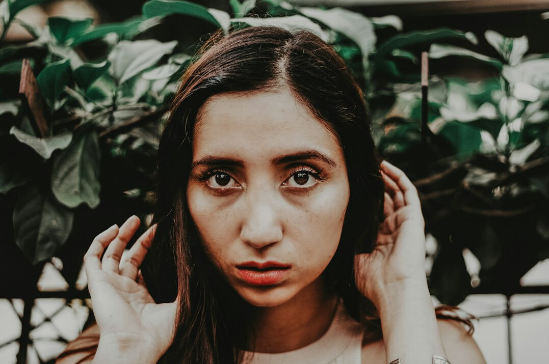 Portrait of a South Asian woman sound supervisor wearing headphones around her neck