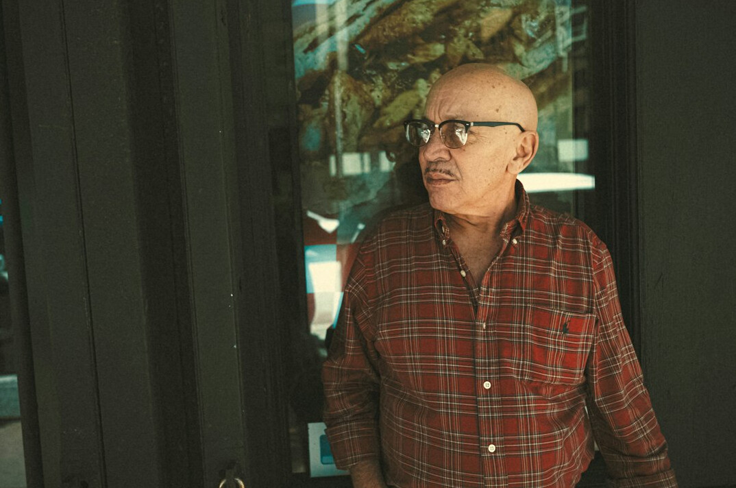 Portrait of an older man studio engineer with grey hair and glasses